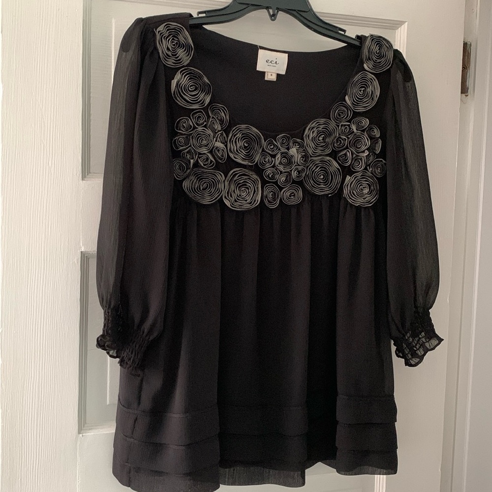 Cute babydoll sweater with unique floral design on front!